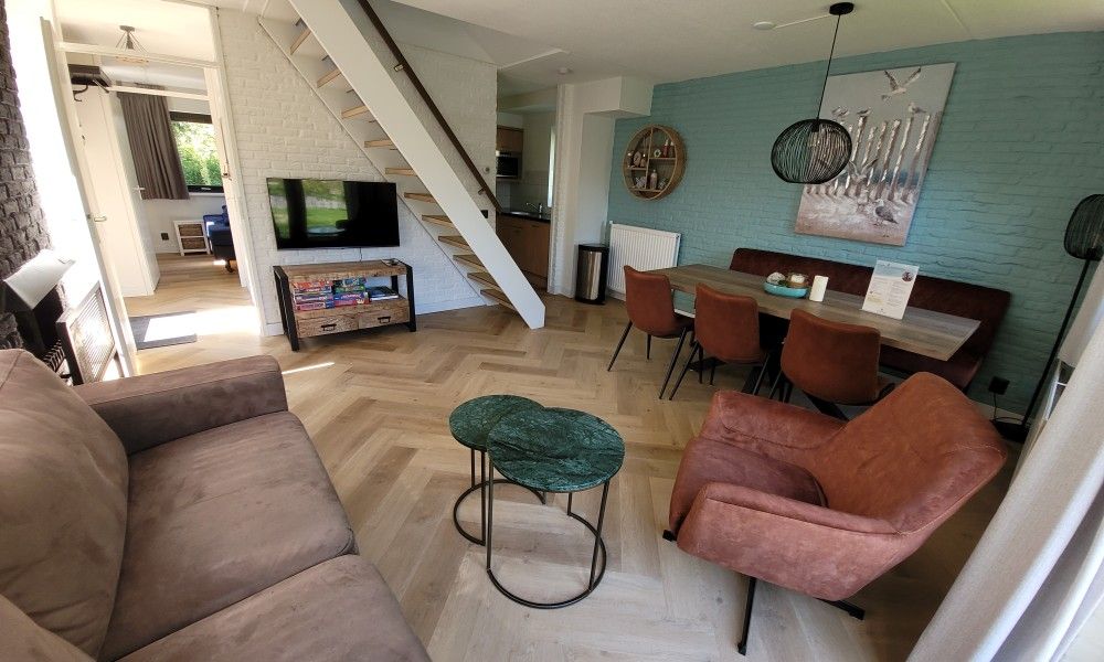 Gezellige woonkamer in vakantiehuis Het Eiland Gevoel, De Cocksdorp, Texel met comfortabele zitruimte en moderne inrichting.