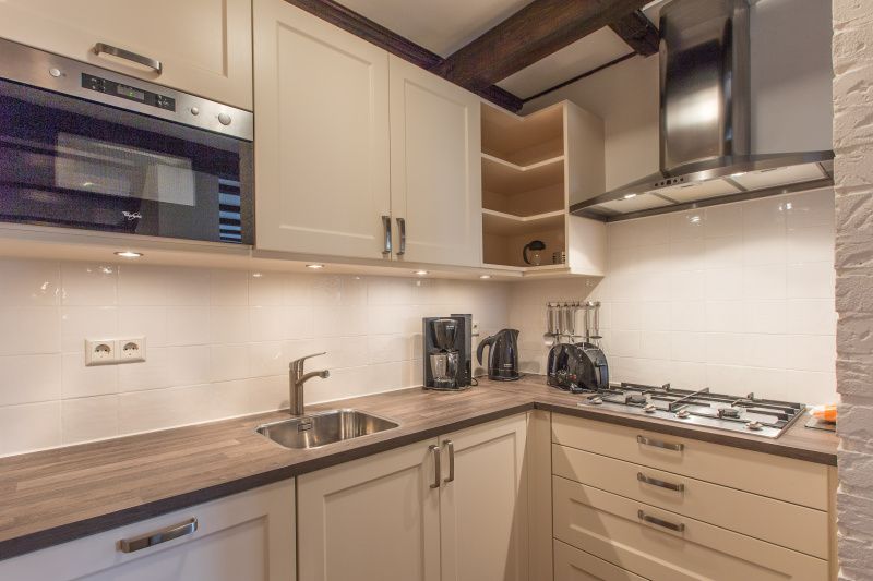 Modern kitchen in Type T-3 vacation home, De Cocksdorp, Texel, with built-in appliances.