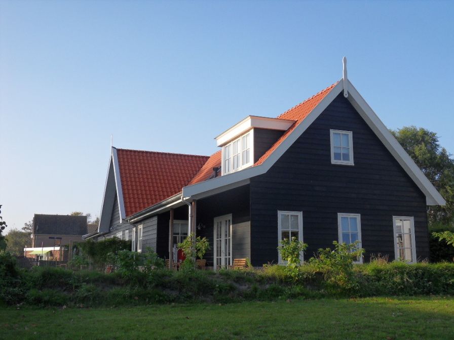 Typ 7 - 2107 Ferienhaus in De Cocksdorp Texel mit schoener Fassade und gruener Umgebung.