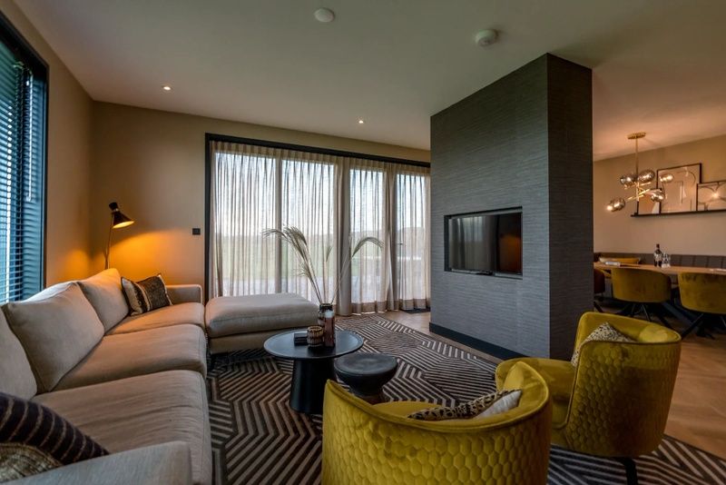 Stylish living room in 6 person vacation home in De Cocksdorp Texel with comfortable seating area.