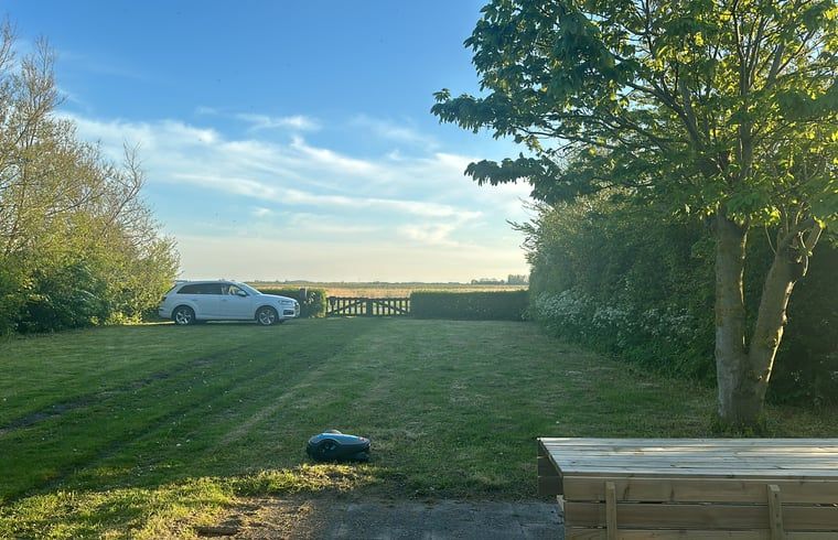 Parking and green area at Holiday home in De Cocksdorp, Texel, Wadden Islands with a view.