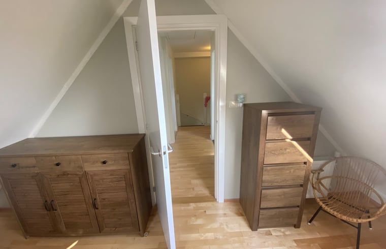 Cozy indoor space with wooden furniture in Holiday home in De Cocksdorp, Texel, Wadden Islands.
