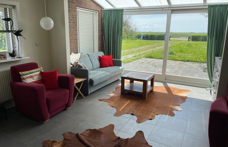Bright living room overlooking the garden in Holiday home in De Cocksdorp, Texel, Wadden Islands.