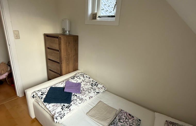 Compact bedroom with storage space in Holiday cottage in De Cocksdorp, Texel, Wadden Islands.