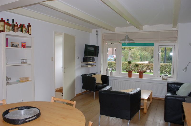 Cozy living room in Kikkertstraat 067, De Cocksdorp, Texel, with comfortable seating area.