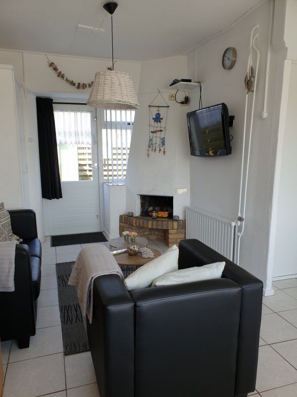 Cozy sitting area with fireplace in Holiday homes Family Bouthoorn, Zuid-Eierland, Texel.