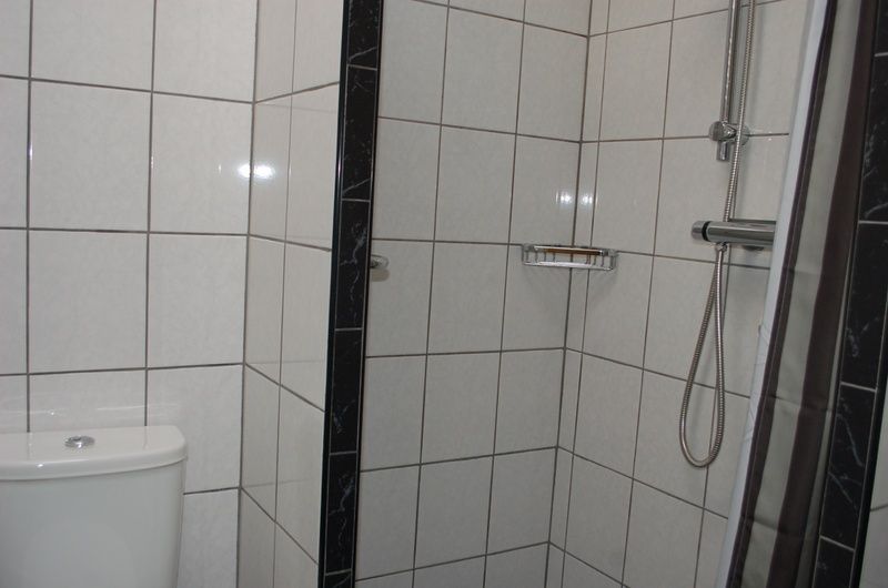 Modernes Badezimmer von Bungalow Tamarisk 212, De Cocksdorp, Texel, mit Dusche und Toilette.