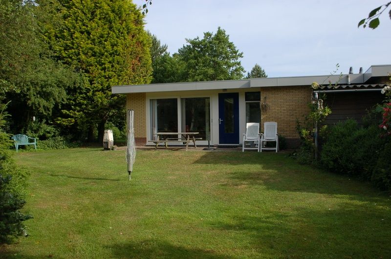 Vorderseite des Bungalows Tamarisk 212 in De Cocksdorp, Texel, mit einladendem Eingang und Garten.