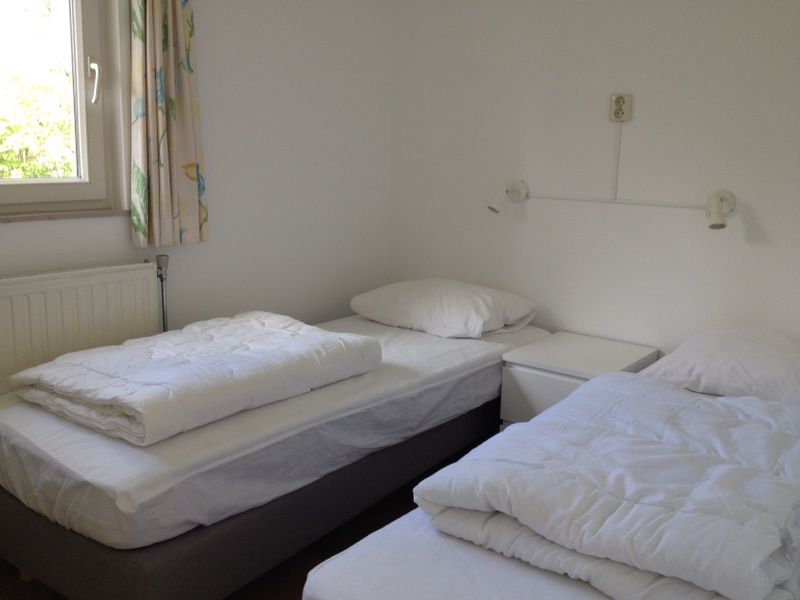 Zweites Schlafzimmer im Ferienhaus Slufteroord 270, De Cocksdorp Texel, mit zwei Einzelbetten fuer einen entspannten Aufenthalt.