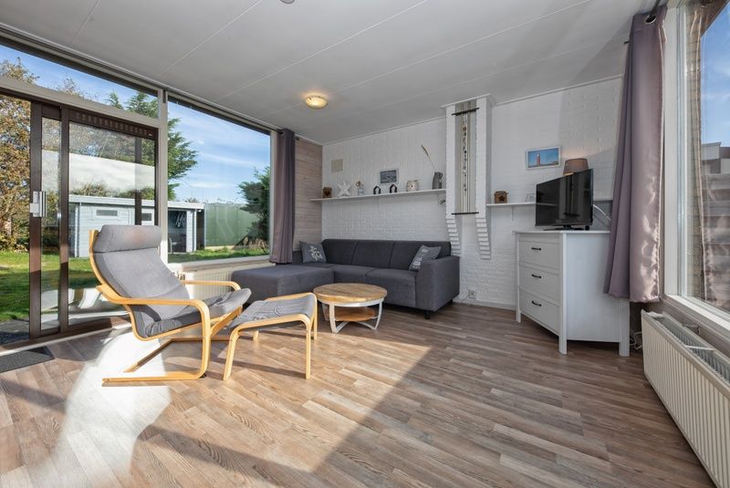 Bright living room of Bungalow Tamarisk 190, vacation home on Texel with comfortable interior.