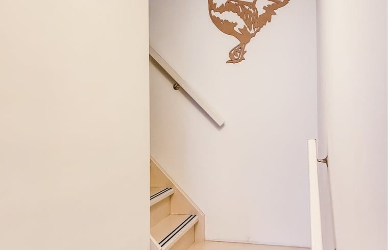 Minimalistisches Treppenhaus mit Dekoration in einem Ferienhaus in De Cocksdorp, Texel.