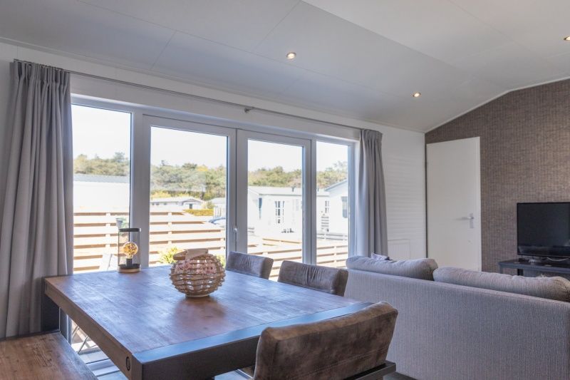 Dining area in Chalet Bregkoog 231, De Koog, Texel overlooking the terrace on Chaletpark Bregkoog.