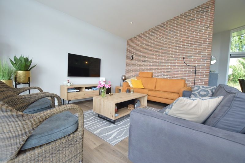 Stylish sitting area in Orchismient 49 vacation home, De Koog, Texel with modern decor and natural accents.