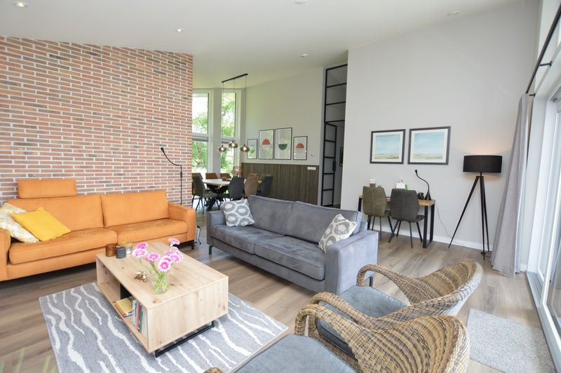 Open living room of Orchismient 49 vacation home in De Koog, Texel, where comfort and style come together.
