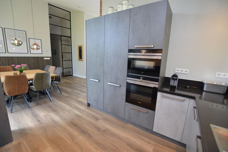 Stylish kitchen of Orchismient 49 vacation home, De Koog, Texel with ample storage and modern finishes.