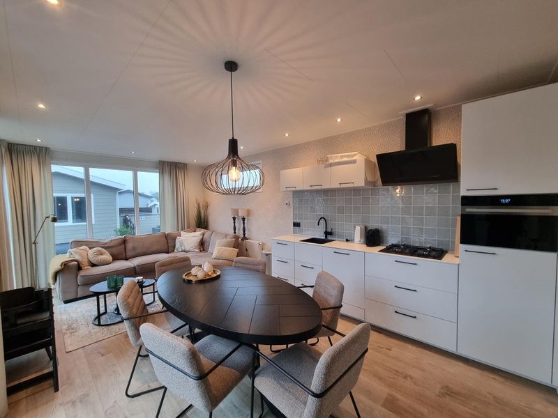 Stylish interior of Chalet Bregkoog 119 with open kitchen in De Koog, Texel, Wadden Islands.