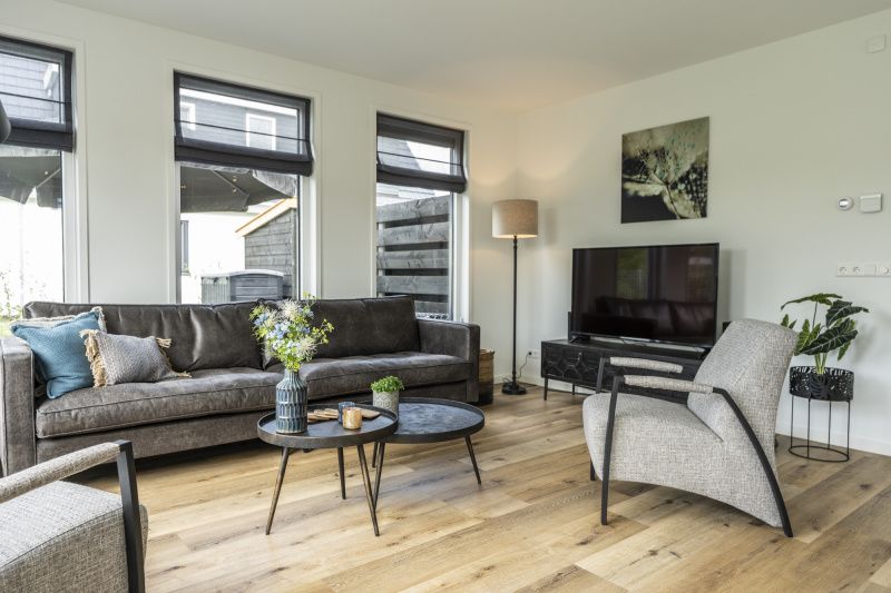 Stylish living room of Villa 41 in De Koog, Texel, with modern decor and lots of natural light.
