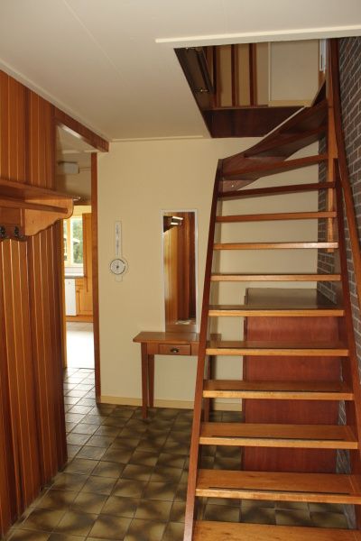 Stairs in Landhuis Landleven No. 81, vacation home in De Koog, Texel with wooden details and access to upper floor.