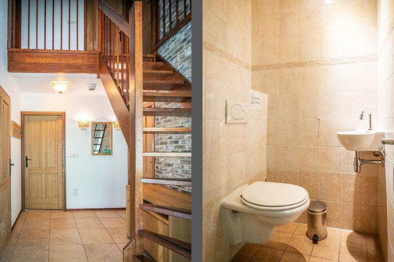Hall and toilet in Villa, De Koog, Texel with wooden staircase and light tiled floor.