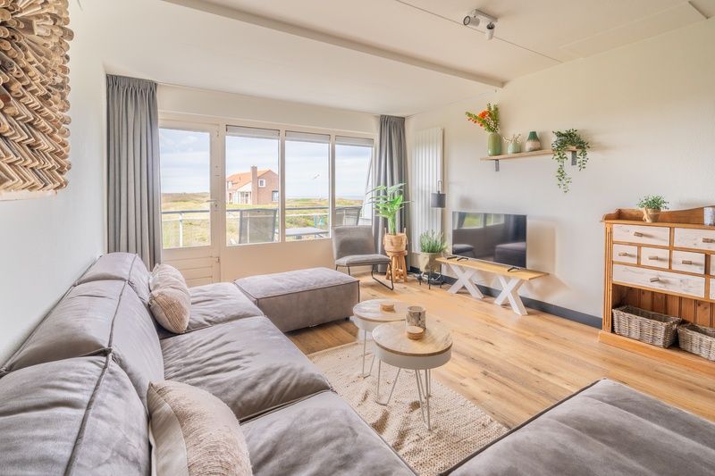 Spacious living room with comfortable sofa in Apartment Juliana 086, De Koog, Texel.