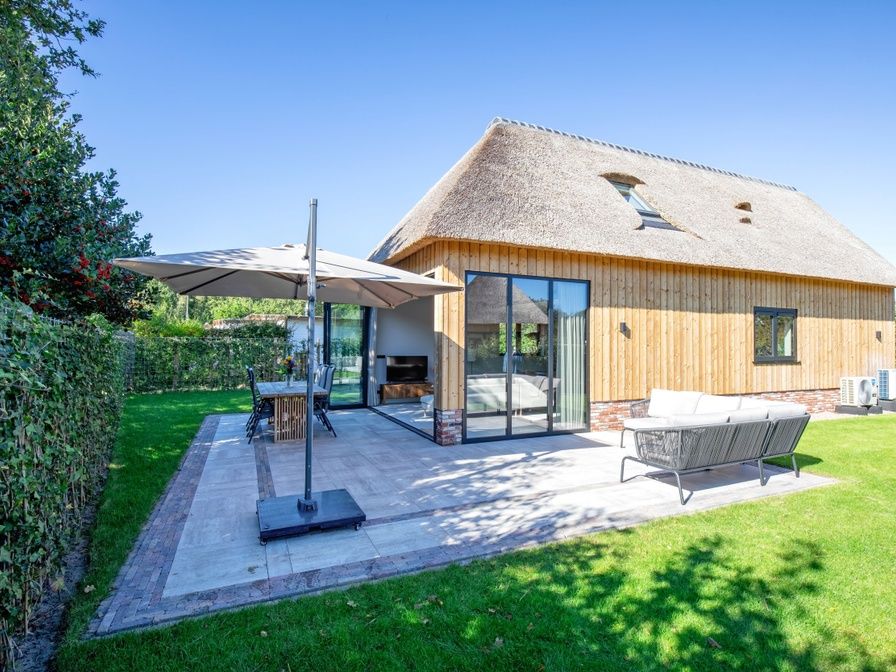 Villa Flo in De Koog, Texel with sunny terrace and comfortable outdoor seating.