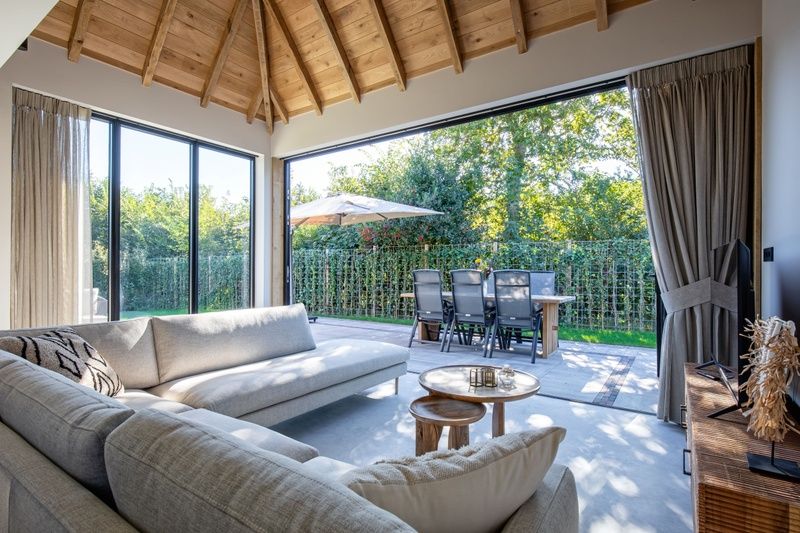 Open living room of Villa Flo in De Koog, Texel with access to the terrace.