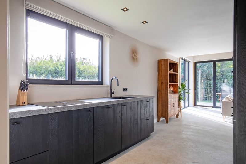 Kitchen of Villa Flo, Texel overlooking the garden and modern furnishings.
