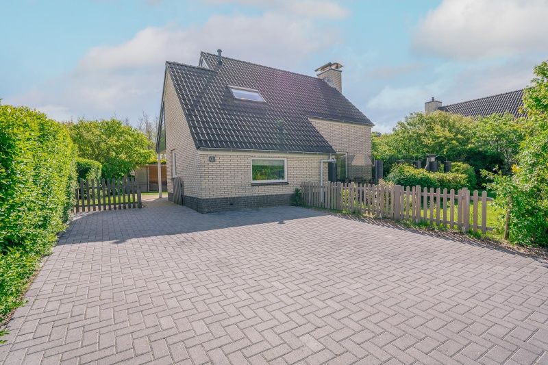 Cozy vacation home Honeysuckle 81 in De Koog, Texel with enclosed garden and spacious driveway, perfect for a relaxing vacation on the Wadden Islands.