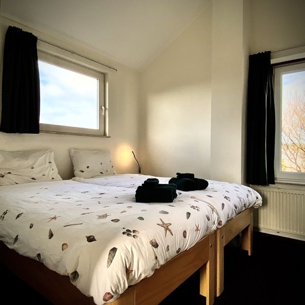 Bright bedroom in Stappeland - Huize 100-1, vacation home in De Koog, Texel, with beautiful view and comfortable bed.