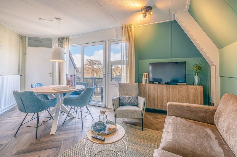 Stylish seating area in Apartment Zeedistel 22, De Koog, Texel with comfortable furniture and views of the surroundings.
