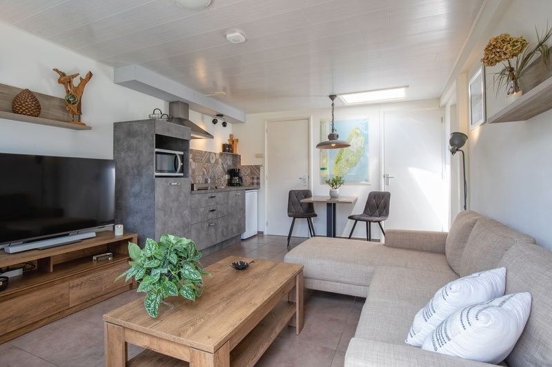 Modern kitchen and dining area in Duo bungalow, vacation home in De Koog, Texel on the Wadden Islands.