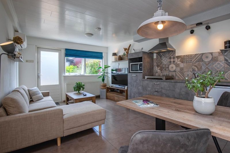 Stylish interior of Duo bungalow, vacation home in De Koog, Texel with open kitchen and sitting area.