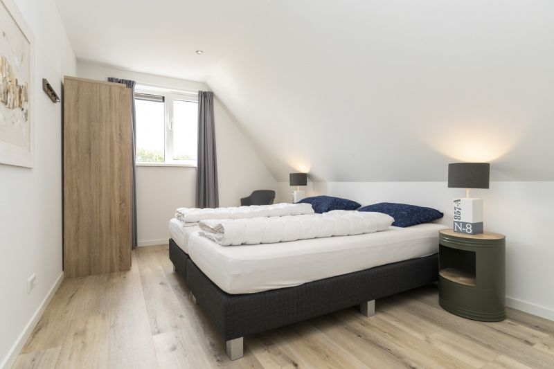 Attractive bedroom under the roof in Villa 21A, De Koog, Texel, vacation home on the Wadden Islands.