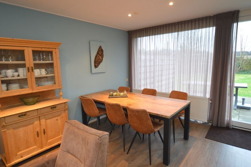 Epelaan 19, De Koog, Texel, has a stylish dining room with wooden furniture.