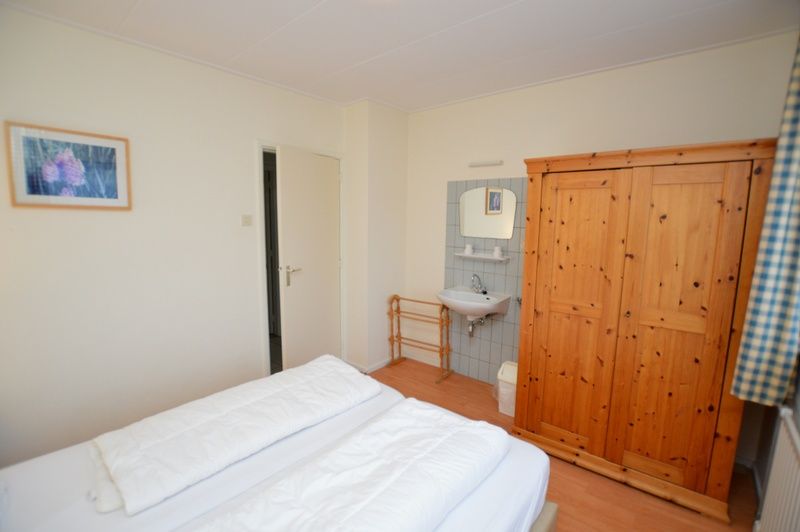 Epelaan 19 vacation home in De Koog, Texel, offers a spacious bedroom with private sink.