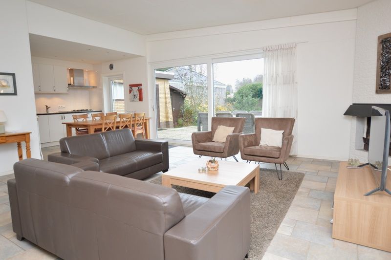 Spacious open living space in Epelaan 31, De Koog, Texel, with access to terrace and views of nature.
