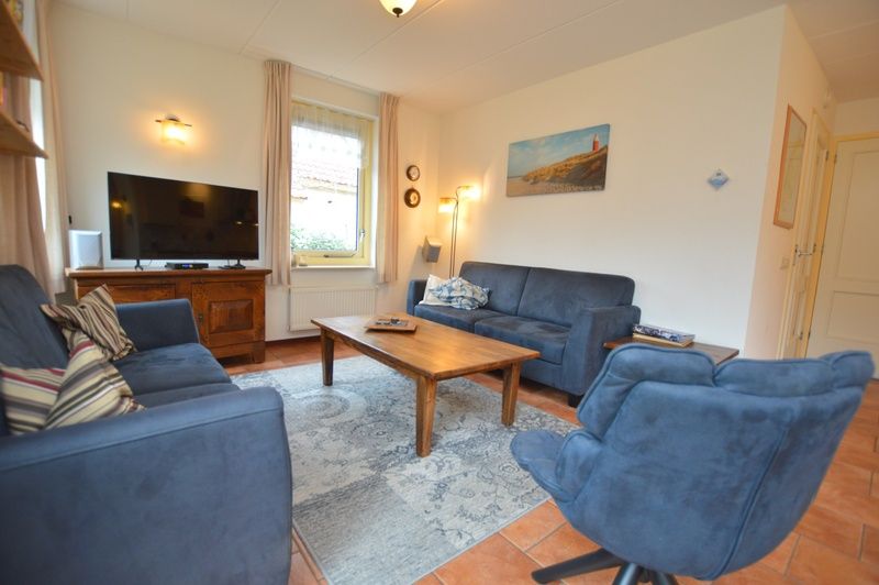 Cozy living room of Holiday Home 7K in De Koog, Texel with comfortable sofas and modern amenities.