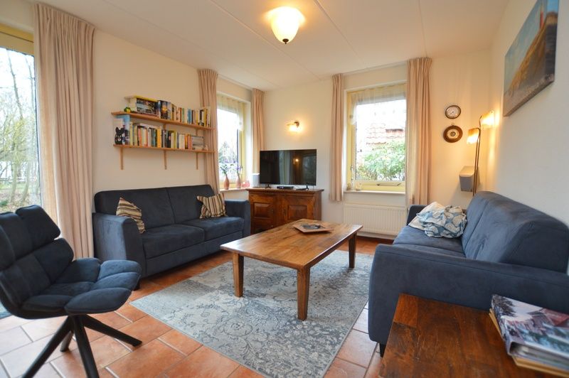 Bright living room in Holiday home 7K, De Koog, Texel with spacious seating area and television for relaxation on the Wadden Islands.