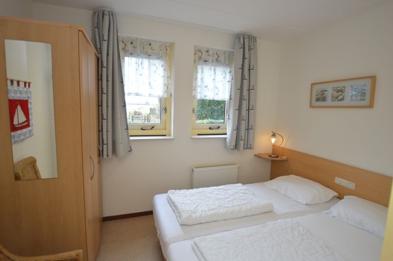 Bedroom in Holiday Home 7K, De Koog, Texel with comfortable beds and restful atmosphere for a good night's sleep.