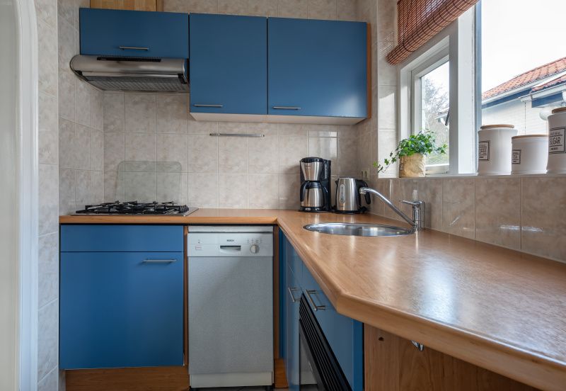 Compact kitchen in Riddertje, vacation home De Koog, Texel. Practical and fully equipped for your convenience.