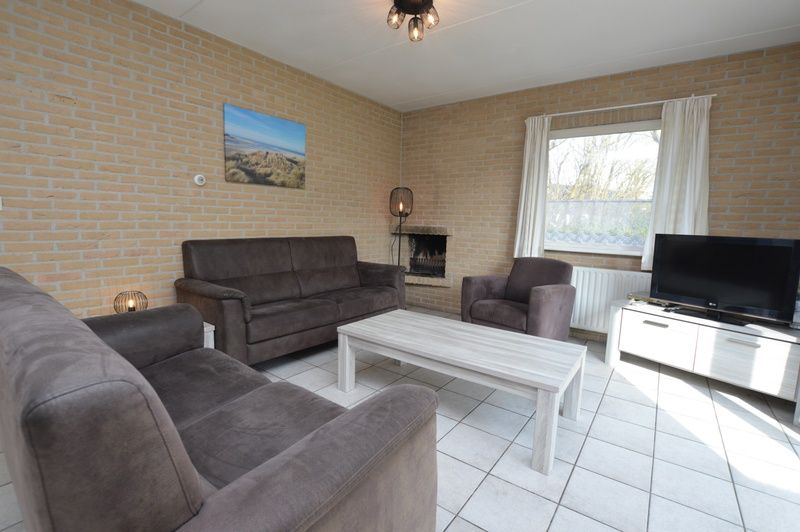 Cozy living room in Holiday home Stappeland 207, De Koog, Texel with comfortable sofas and lots of natural light.