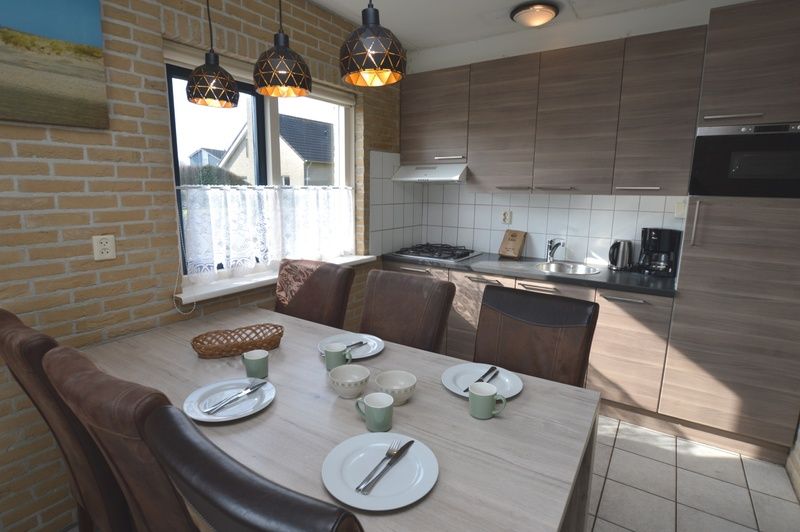 Fully equipped kitchen in Holiday home Stappeland 207, De Koog, Texel with modern amenities and dining area.
