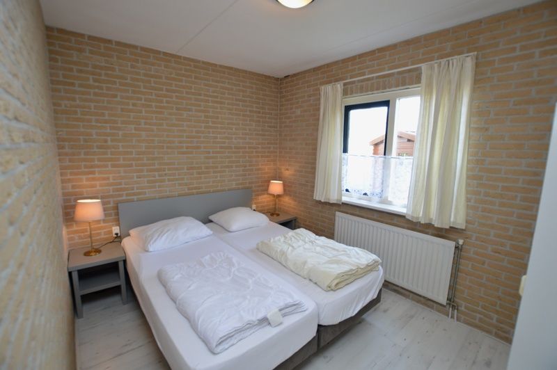 Comfortable bedroom with double bed in Holiday home Stappeland 207, De Koog, Texel for a good night's sleep.
