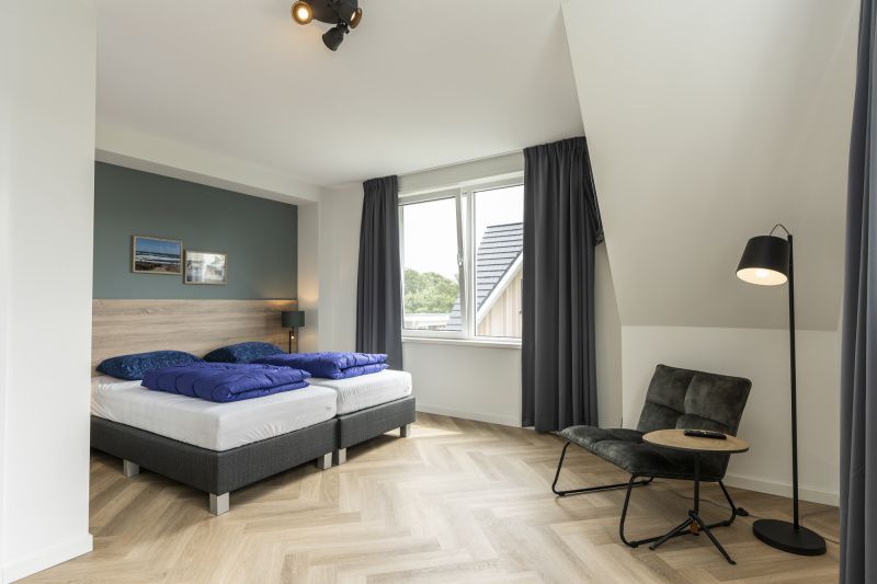 Spacious bedroom with view in Villa 39, De Koog, Texel. Comfortable vacation home on the Wadden Islands.