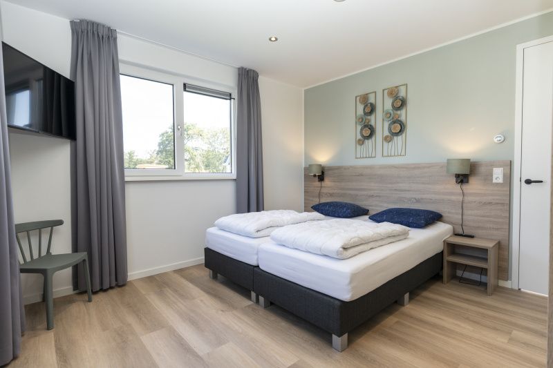 Bedroom in Villa 37a, De Koog, Texel, vacation home with double bed and quiet atmosphere for a relaxing stay.