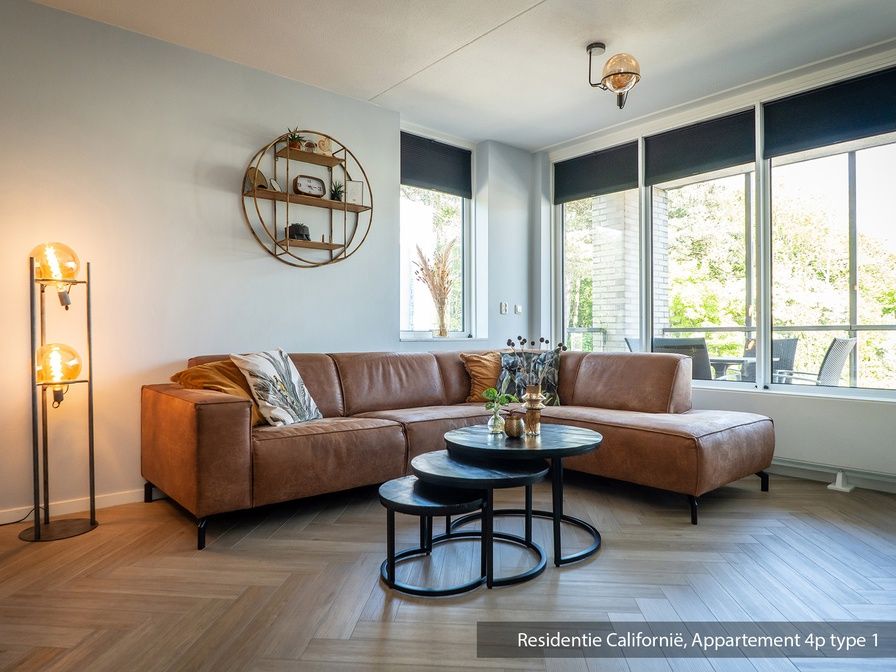 Cozy living room in Type 1 vacation home, De Koog, Texel with comfortable sofa and lots of natural light.