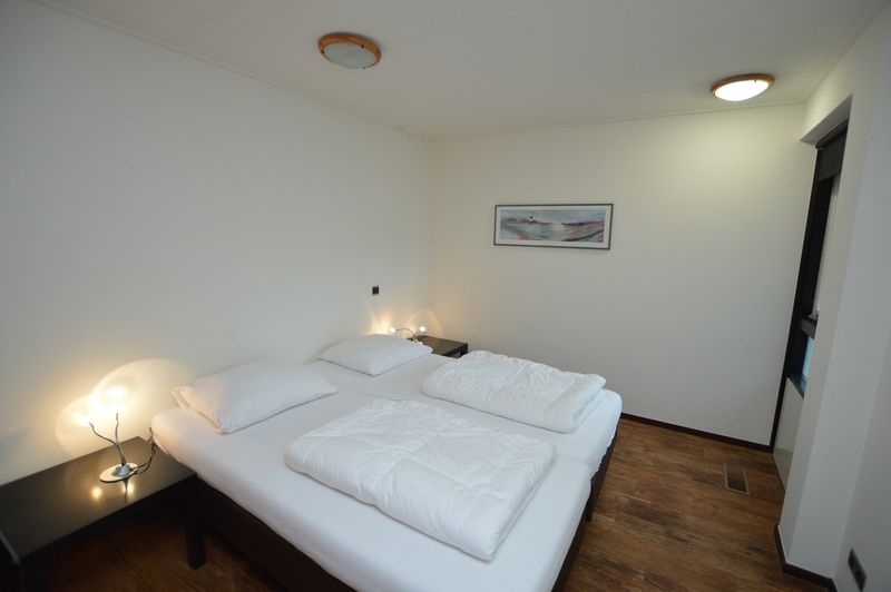 Cozy bedroom in Orchismient 28 De Koog Texel with relaxing atmosphere.