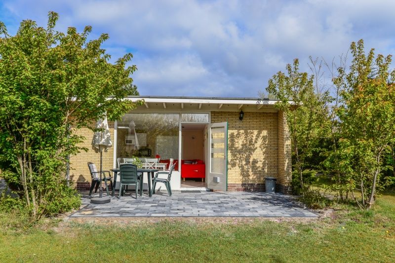 Cozy terrace of Bungalow 51 in Bungalowpark 't Luwe Land, De Koog, Texel, with garden furniture.