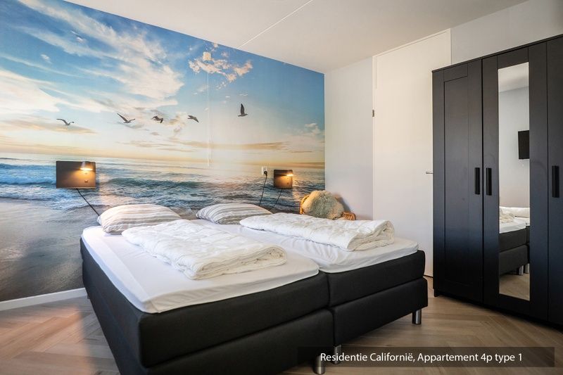 Bedroom in Type 1 vacation home, De Koog, Texel with double bed and beach mural.