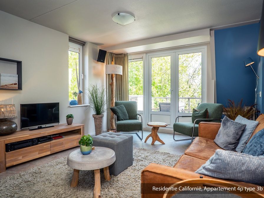 Cozy living room in Type 3B vacation home in De Koog, Texel with comfortable seating area and lots of natural light.
